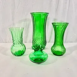 Sale Photo Thumbnail #30: Set of three vintage emerald green glass vases in varying ribbed and textured styles.