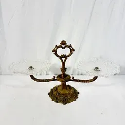 Sale Photo Thumbnail #269: Vintage double-tier candy dish featuring an ornate brass frame and handle with two clear pressed glass inserts.
