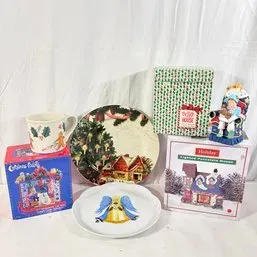 Sale Photo Thumbnail #94: Collection of Christmas-themed decor including a lighted porcelain house with original box, decorative plates, a mug, and a seated figurine.