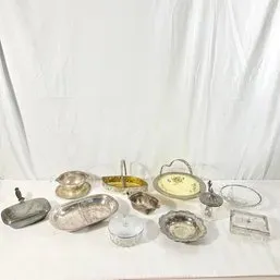Sale Photo Thumbnail #106: Assortment of silver-plated and glass serving pieces, including a silent butler, gravy boat with saucer, handled baskets, and various bowls.