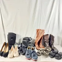Sale Photo Thumbnail #153: Assorted collection of men's and women's footwear including tall leather riding boots, pumps, sneakers, sandals, and winter boots in various styles.