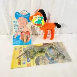Sale Photo Thumbnail #188: Collection of vintage novelty items and toys, including a packaged Regency G.I. Soldier figure, a Gumby Pokey plush, and a vintage King of the Golden Wet safety pin package.