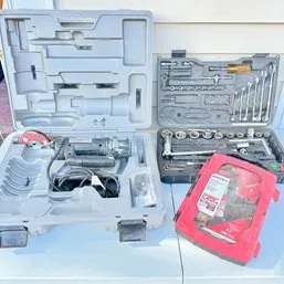 Sale Photo Thumbnail #11: Assorted power tool sets and socket wrench kits, including a power rotary cutter and a Milwaukee accessory case.