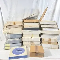 Sale Photo Thumbnail #228: Large stack of vintage boxed collectibles and dinnerware items, including boxed silverplate pieces from Gorham.