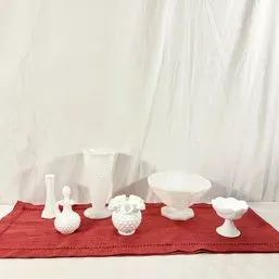 Sale Photo Thumbnail #78: Collection of mid-century vintage white milk glass decor, including a Fenton hobnail decanter, rose bowl, compotes, and vases.
