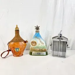 Sale Photo Thumbnail #112: Collection of three vintage novelty decanters, including a leather-wrapped leather-strap bottle, a vintage Scottish mist decanter, and a chrome Rolls-Royce grill decanter.