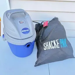 Sale Photo Thumbnail #36: Compact Shop-Vac wet/dry vacuum in blue and gray, paired with a black Shacke Pak drawstring bag.