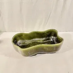 Sale Photo Thumbnail #18: Vintage mid-century olive green freeform ceramic planter with a glossy glazed finish.
