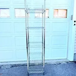 Sale Photo Thumbnail #8: Tall, narrow chrome wire shelving unit featuring five adjustable shelves, suitable for storage or display.