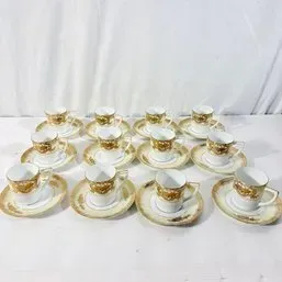 Sale Photo Thumbnail #76: Set of twelve vintage fine porcelain demitasse cups and saucers featuring heavy gold filigree trim.