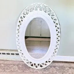 Sale Photo Thumbnail #105: Vintage white painted oval wall mirror featuring an intricate lattice work border.
