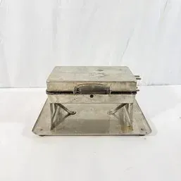 Sale Photo Thumbnail #3: Vintage metal waffle iron or sandwich press mounted on a metal base tray, showing light surface wear and tarnish.