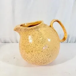 Sale Photo Thumbnail #176: Vintage studio pottery pitcher featuring a bulbous body and speckled yellow glaze.