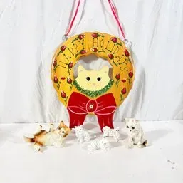 Sale Photo Thumbnail #23: Hand-painted cat holiday wreath door hanging accompanied by five small cat figurines in various poses.