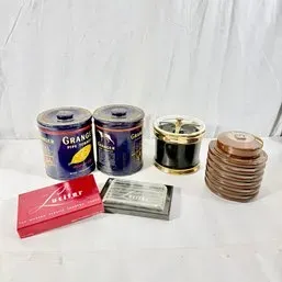 Sale Photo Thumbnail #127: Collection of vintage tobacciana items, including Granger Pipe Tobacco tins, a brass-trimmed ashtray container, a ribbed ceramic tobacco jar, and packaged accessories.