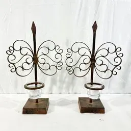 Sale Photo Thumbnail #29: Pair of rustic metal and wood votive candle holders with scrolled butterfly-shaped wire accents and glass cups.