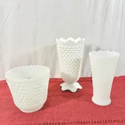 Sale Photo Thumbnail #148: Collection of three mid-century white milk glass vases featuring hobnail and textured embossed patterns.