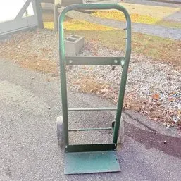 Sale Photo Thumbnail #65: Green steel two-wheel hand truck, showing light wear from use.