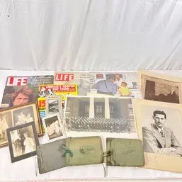 Sale Photo Thumbnail #164: Collection of vintage paper ephemera, including mid-20th-century LIFE magazines, framed studio photographs, group portraits, and small string-bound booklets.