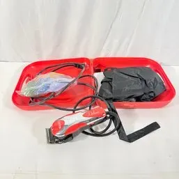 Sale Photo Thumbnail #172: Wahl Deluxe Chrome Pro haircutting kit in red plastic carrying case, featuring corded electric clippers, color-coded guide combs, and accessories.