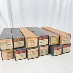 Sale Photo Thumbnail #54: Collection of vintage QRS and Imperial player piano word rolls in their original cardboard boxes.