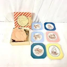 Sale Photo Thumbnail #173: Vintage set of six colorful ceramic coasters featuring historical scenes, accompanied by their original striped box.