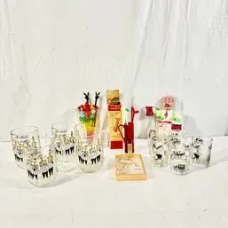 Sale Photo Thumbnail #87: Collection of vintage barware accessories including printed glasses, cocktail picks, a novelty bartender figurine, and boxed items.