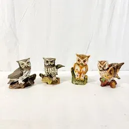 Sale Photo Thumbnail #31: Collection of four vintage painted ceramic and resin owl figurines, displayed in a row.