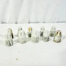 Sale Photo Thumbnail #161: Collection of ten vintage porcelain thimbles featuring printed text and metric sizing details.