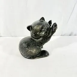 Sale Photo Thumbnail #47: Vintage dark gray ceramic kitten figurine shown in a playful paw-up posture.
