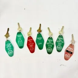 Sale Photo Thumbnail #179: Collection of vintage mid-century hotel room key fobs featuring Holiday Inn and Ramada Inn branding.