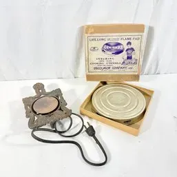 Sale Photo Thumbnail #108: Vintage Excelsior Company Life Long Flame Pad in original box shown next to an antique cast iron electric hot plate trivet.
