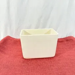 Sale Photo Thumbnail #147: Simple off-white ceramic rectangular planter or catchall dish displayed on a red cloth.