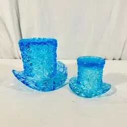 Sale Photo Thumbnail #134: Pair of vintage blue pressed glass top hat figurines or tooth pick holders featuring a daisy and button pattern.