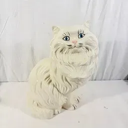Sale Photo Thumbnail #28: Vintage white ceramic Persian cat figurine featuring hand-painted blue eyes and detailed textured fur.