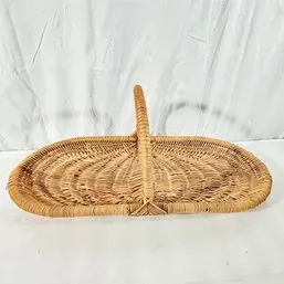 Sale Photo Thumbnail #220: Vintage shallow woven wicker flower or garden basket with a central fixed handle.