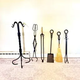 Sale Photo Thumbnail #252: Vintage wrought iron fireplace tool set including a stand, tongs, shovel, broom, and poker.