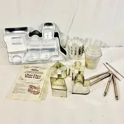 Sale Photo Thumbnail #19: Vintage Wilton train cake pan set with original instruction pamphlet, tin cookie cutters, and mini tart molds.