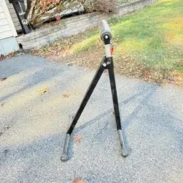 Sale Photo Thumbnail #26: Adjustable metal roller stand with a black A-frame base, suitable for woodworking and supporting long materials.