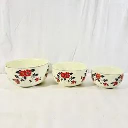 Sale Photo Thumbnail #213: Set of three vintage ceramic mixing bowls featuring a red floral and black leaf pattern on a cream background.