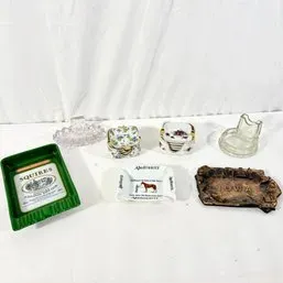 Sale Photo Thumbnail #144: Collection of vintage ashtrays, including advertising, ceramic floral stackable sets, pressed glass, and an Iowa souvenir dish.