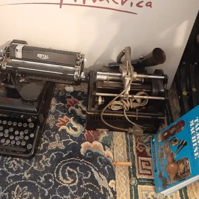 Vintage Royal manual typewriter alongside an antique Ediphone dictation machine and a copy of 'The Talking Machine' reference...