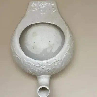 Vintage Ornate White Glazed Ceramic Wall-Mounted Urinal with Floral Relief Design