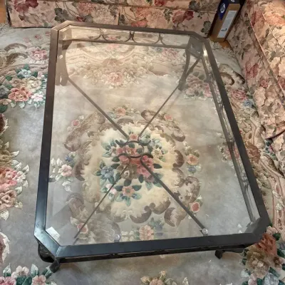 Ornate Wrought Iron & Glass Top Coffee Table with Lion Head Medallions and Scrollwork