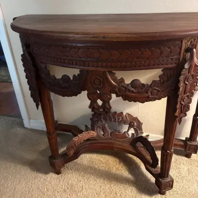 Ornately Carved Wood Demilune Console Table with Floral Garland & Scrollwork Details