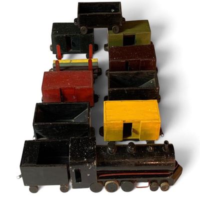 Antique home-crafted wooden train.  Box cars have sliding doors.