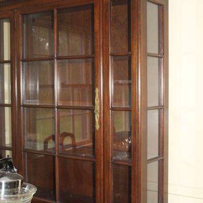 Sale Photo Thumbnail #42: Traditional mahogany china cabinet featuring glass paneled doors, dentil molding, and a broken-arch pediment top.