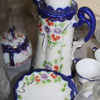 Sale Photo Thumbnail #53: Vintage hand-painted porcelain chocolate pot set featuring cobalt blue trim, gold accents, and a delicate floral motif with matching sugar bowl and saucers.