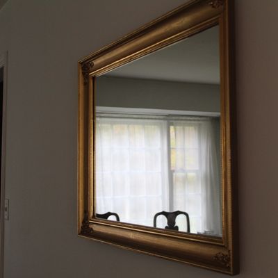 Sale Photo Thumbnail #4: Large rectangular wall mirror featuring an ornate gilded gold frame with corner embellishments.