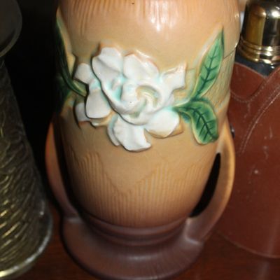 Sale Photo Thumbnail #46: Vintage Roseville Magnolia art pottery vase featuring embossed white blooms and green leaves on a tan and brown textured background.